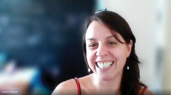 A woman with a red shirt and a smile on her face. Description generated by AI