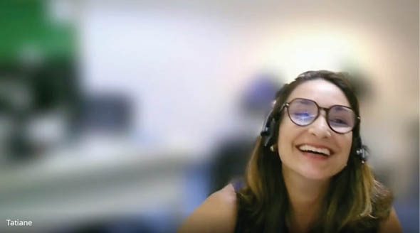 A woman wearing glasses and a blue shirt is smiling. Description generated by AI
