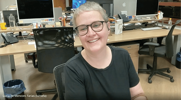 A woman is sitting in an office chair with a black shirt on. Description generated by AI