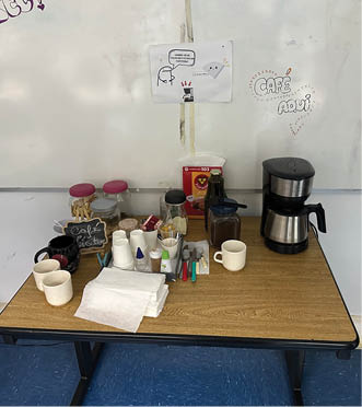 A table with a coffee maker and a cup of coffee on it. Description generated by AI