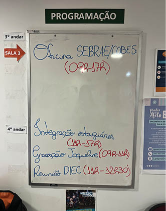 A green sign with white letters pointing to the left. Description generated by AI